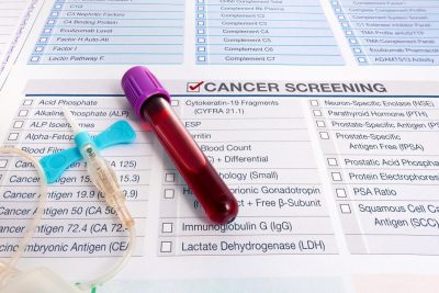 Blood test for cancer lays on medical form for cancer screening